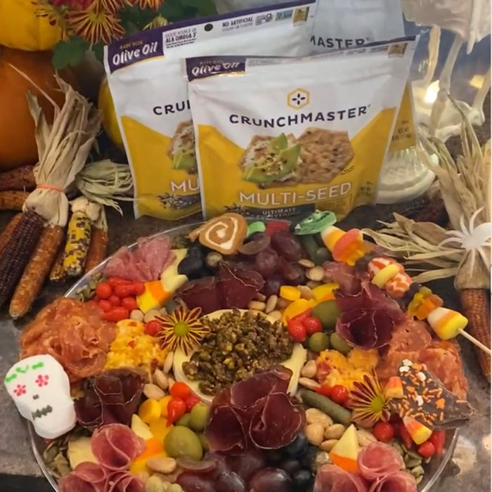 Spooky Delights: Halloween Crunchmaster Charcuterie Board with Candy Corn Brie