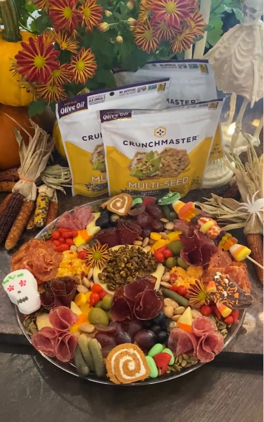 Spooky Delights: Halloween Crunchmaster Charcuterie Board with Candy Corn Brie